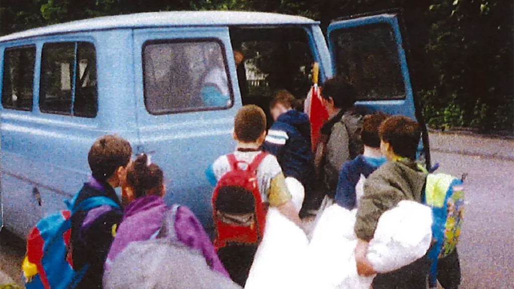 An old photograph of children getting onto a mini bus for a day trip - approx 1975